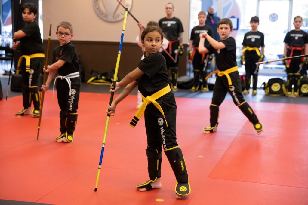 A group of children in Gi Training With Colorful Stick at Victory Martial Arts, Blossom Hill, Arizona