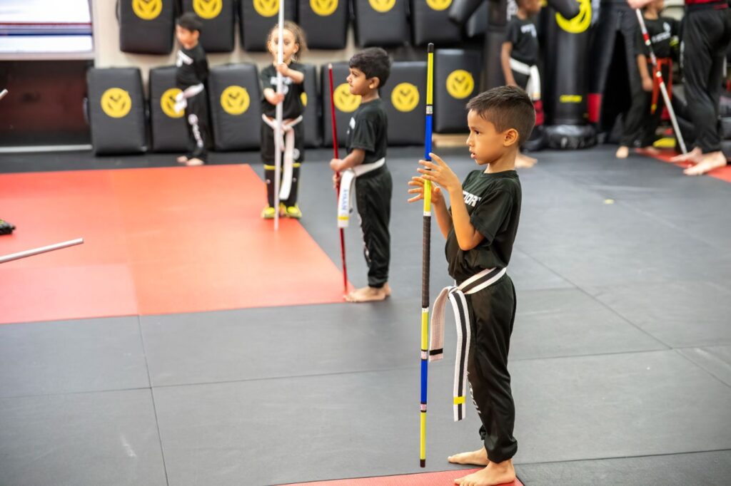 Four Kids With Sticks Alligned During the Session at Victory Martial Arts, Ocoee, FL