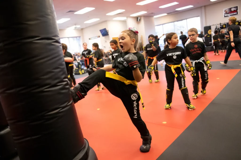 A girl Practices Kicking With Kicking Bag at Victory Martial Arts Hardy Oak, Texas