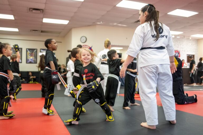 Little Girl Smiling During Workout With Lady Instructor at Victory Martial Arts, Littleton, Colorado