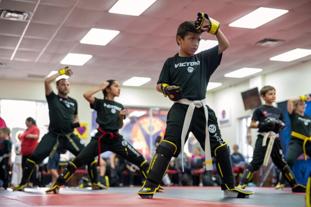 Boy With Other Kids in the Background Practices Karate Moves at Victory Martial Arts in Shadow's Hills Nevada