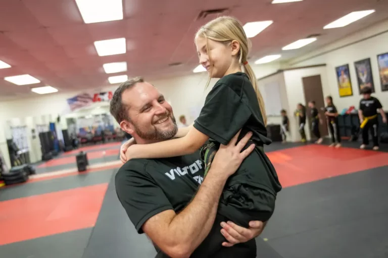 Father in Victory Martial Arts Shirt Holding His Daughter in Clermont Florida
