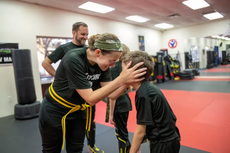 Mother in Victory Martial Arts Shirt Holding Her Son in Clermont Florida
